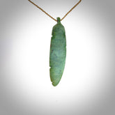 A hand carved large New Zealand Jade feather necklace. The cord is a tan colour and is a fixed length. A large sized hand made Jade feather necklace by New Zealand artist Kerry Thompson. One off work of art to wear.